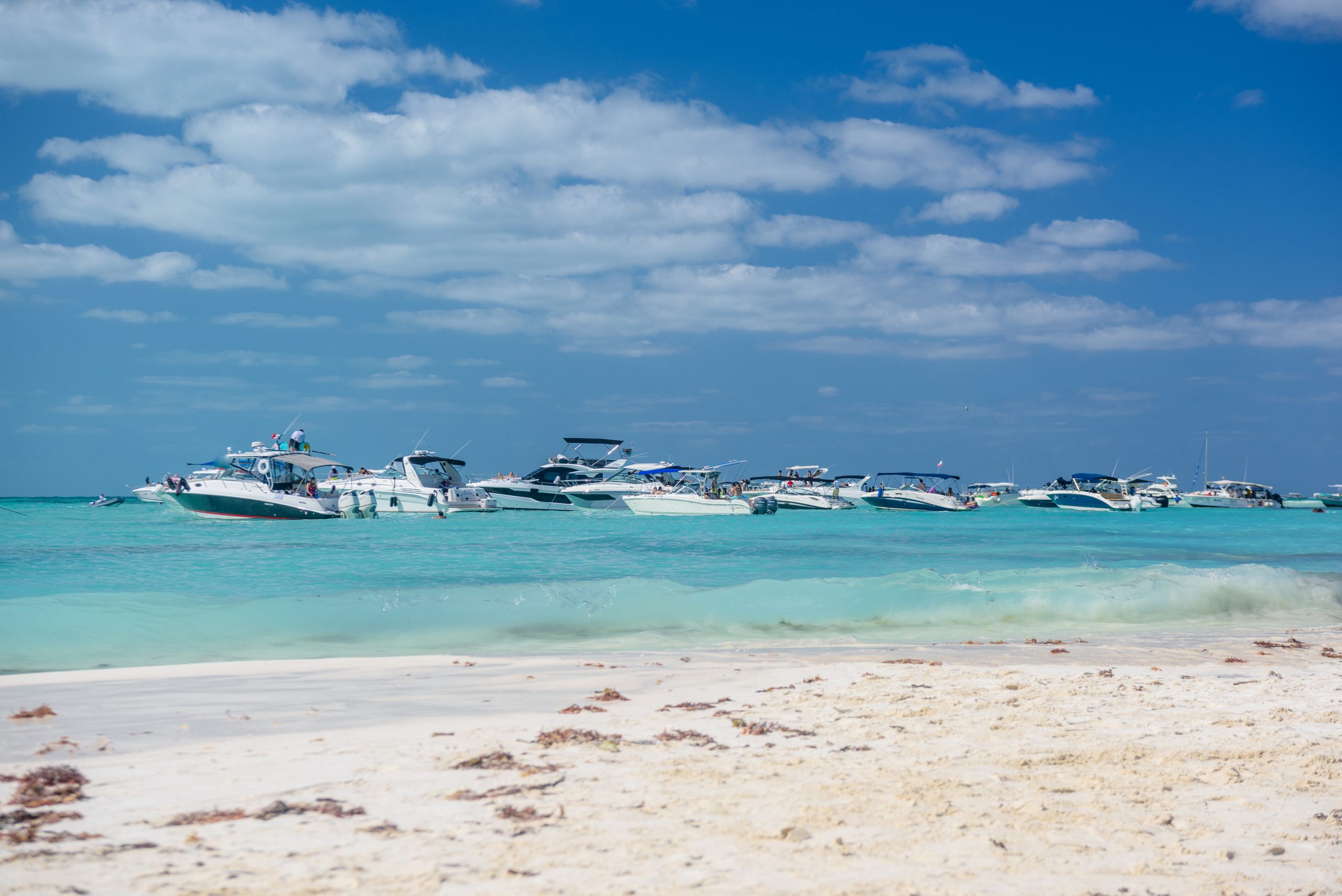 White speed boats and yachts in turquoise azure caribbean sea, Isla Mujeres island, Caribbean Sea, Cancun, Yucatan, Mexico.